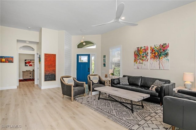 living room with ceiling fan and light hardwood / wood-style floors