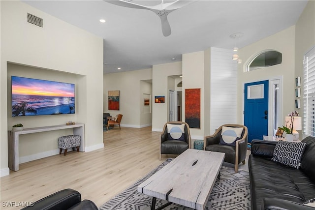 living room featuring ceiling fan and light wood-type flooring