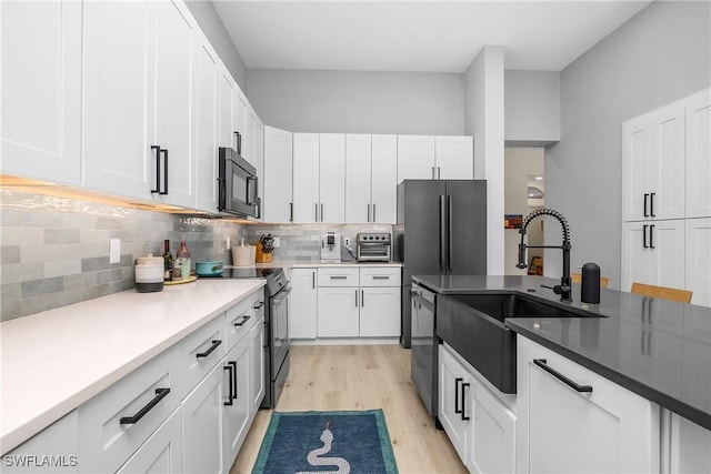 kitchen featuring appliances with stainless steel finishes, sink, and white cabinets