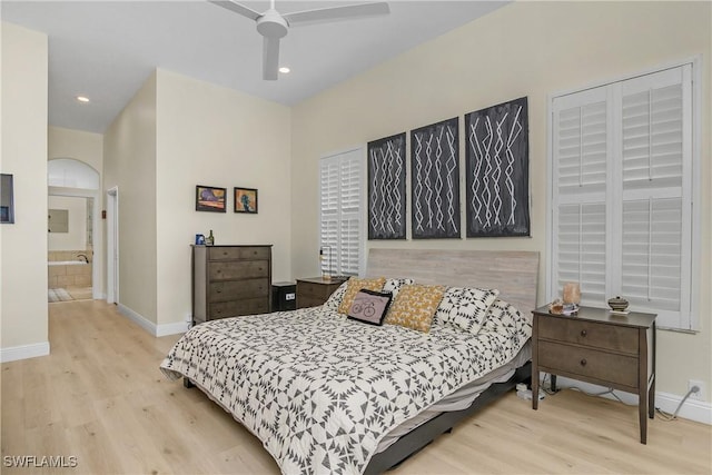 bedroom featuring ensuite bath, light hardwood / wood-style floors, and ceiling fan