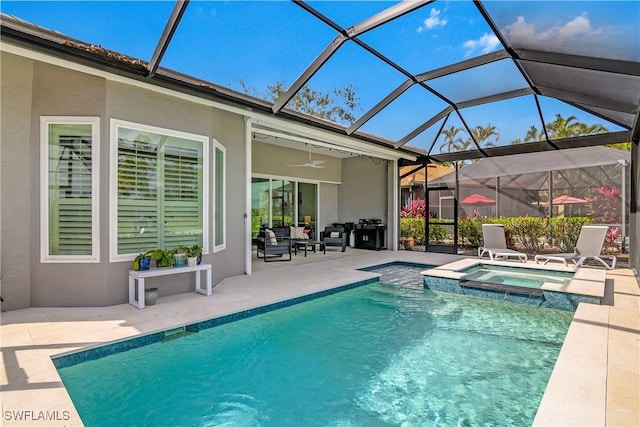 view of swimming pool with ceiling fan, a patio area, glass enclosure, and an in ground hot tub