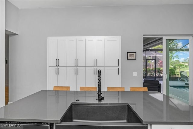 kitchen featuring sink and white cabinets