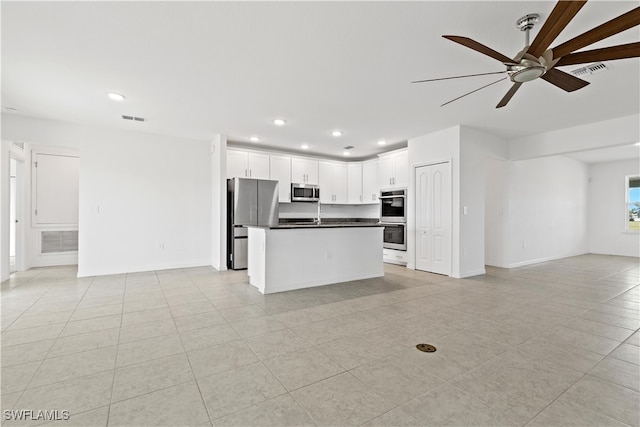 kitchen featuring white cabinets, stainless steel appliances, light tile patterned floors, and ceiling fan