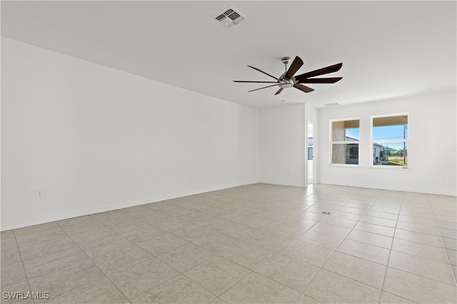 tiled empty room with ceiling fan