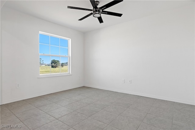 unfurnished room with ceiling fan and light tile patterned floors