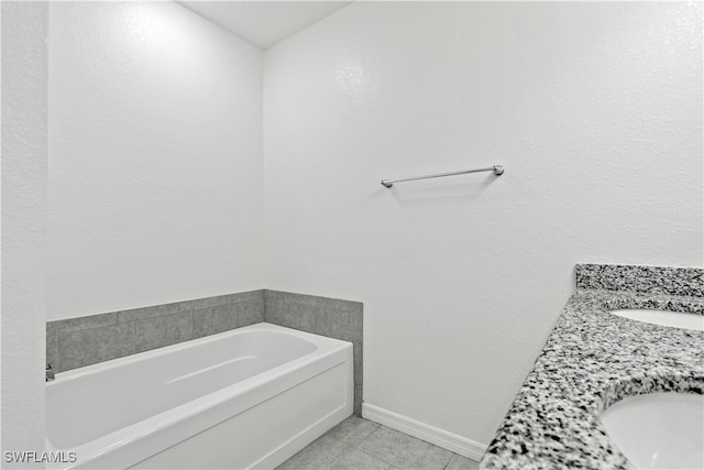 bathroom featuring vanity, tile patterned floors, and a bathing tub