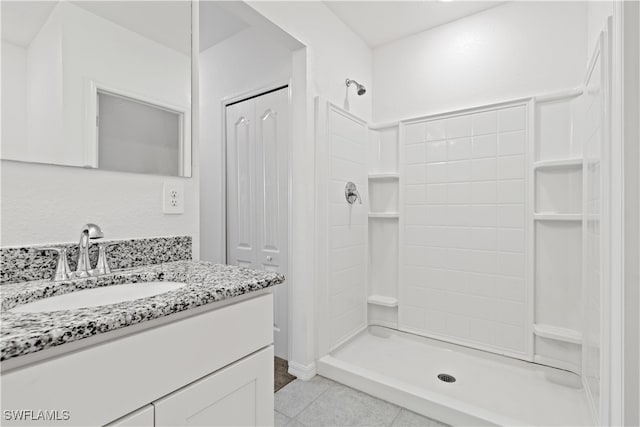 bathroom with vanity, walk in shower, and tile patterned floors