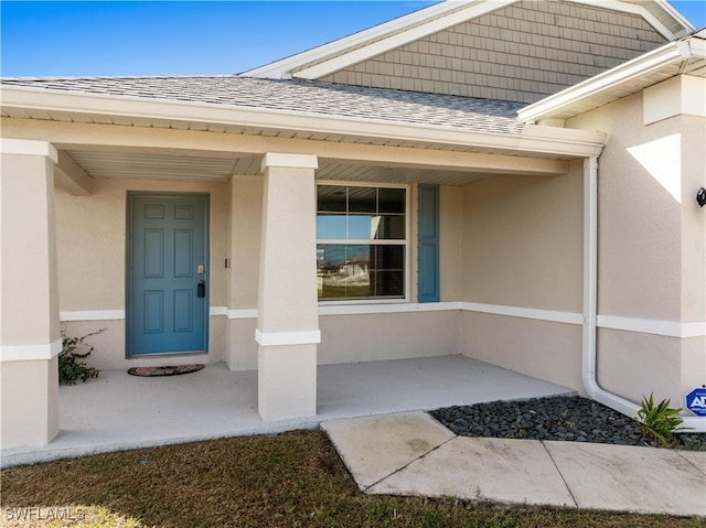 view of exterior entry with a porch