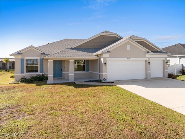 ranch-style house featuring a front yard and a garage