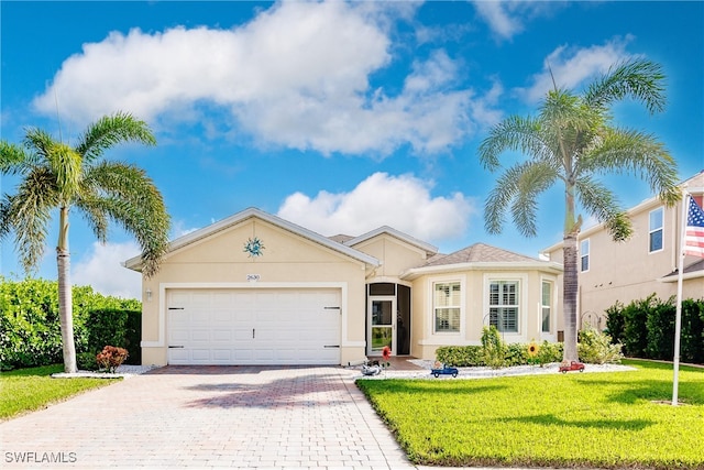 view of front of property featuring a front lawn and a garage