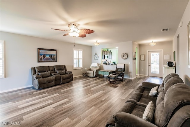 living room featuring light wood-type flooring and ceiling fan