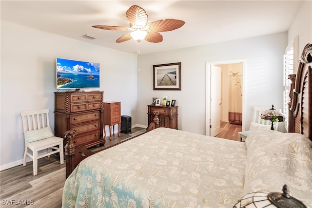 bedroom with connected bathroom, ceiling fan, and light hardwood / wood-style flooring