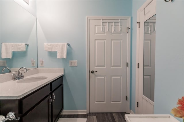 bathroom with hardwood / wood-style floors and vanity