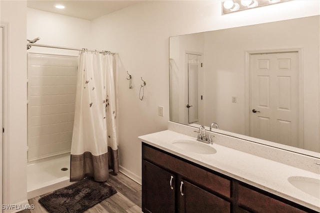 bathroom featuring hardwood / wood-style floors, vanity, and a shower with curtain