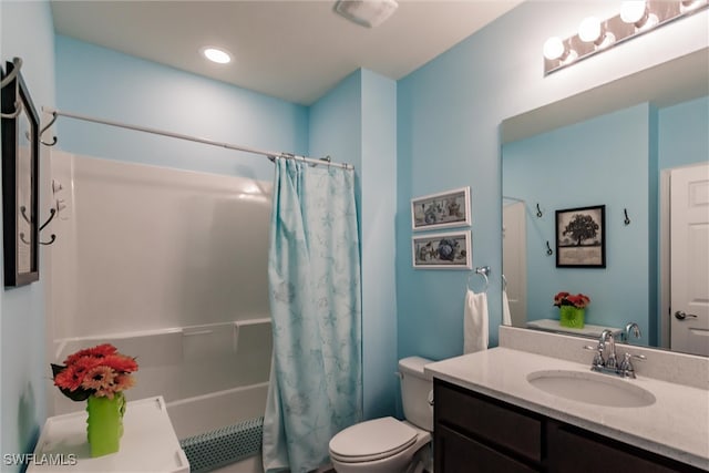 full bathroom featuring vanity, shower / bath combo with shower curtain, and toilet