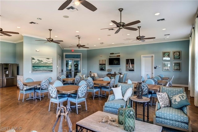 living room featuring hardwood / wood-style flooring and crown molding