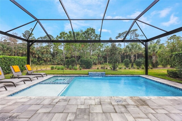 view of swimming pool featuring glass enclosure and a patio area