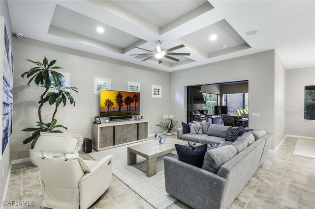 living room with beamed ceiling, ceiling fan, and coffered ceiling