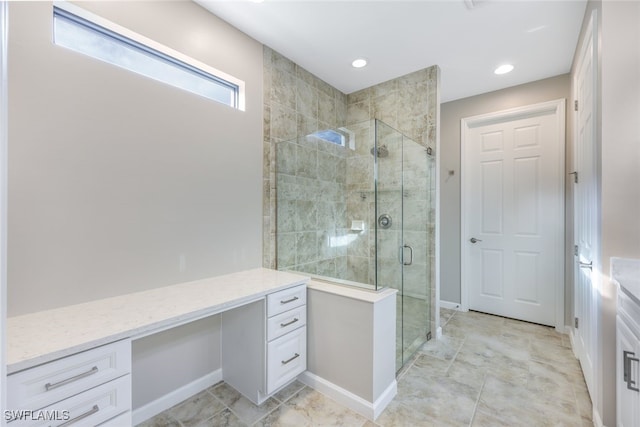 bathroom featuring vanity and a shower with door