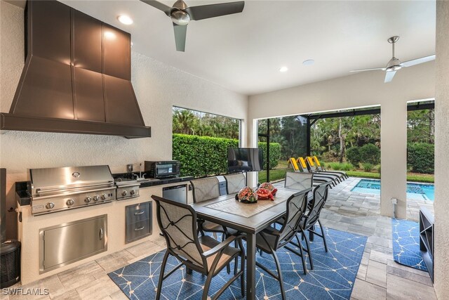 view of patio / terrace with grilling area, ceiling fan, and exterior kitchen