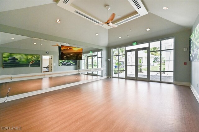 workout area with baseboards, wood finished floors, french doors, high vaulted ceiling, and recessed lighting