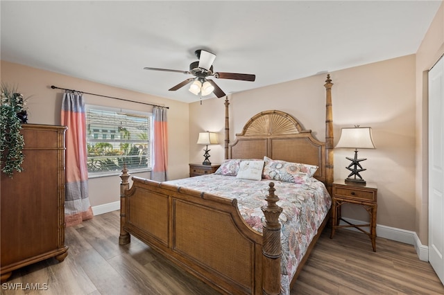 bedroom with dark hardwood / wood-style flooring and ceiling fan