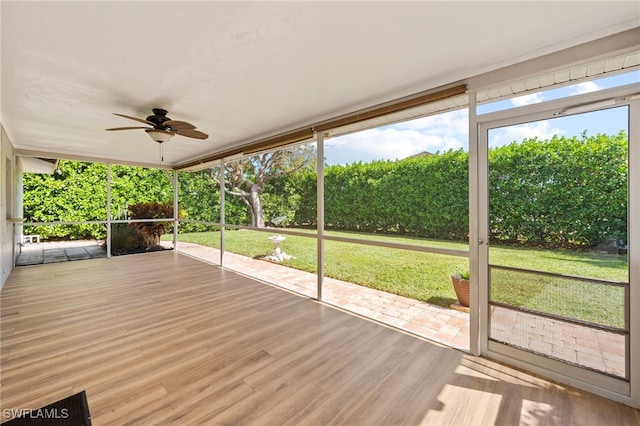 unfurnished sunroom with ceiling fan and plenty of natural light