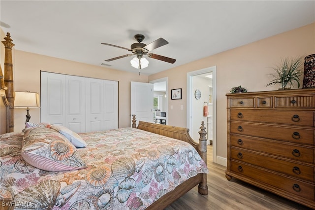 bedroom with light hardwood / wood-style floors, ceiling fan, and a closet