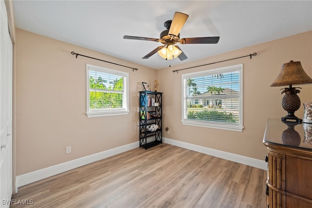 bedroom featuring light hardwood / wood-style flooring, multiple windows, and ceiling fan