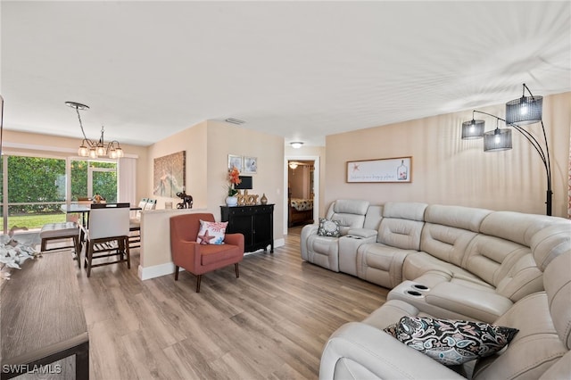 living room featuring light hardwood / wood-style flooring and a chandelier