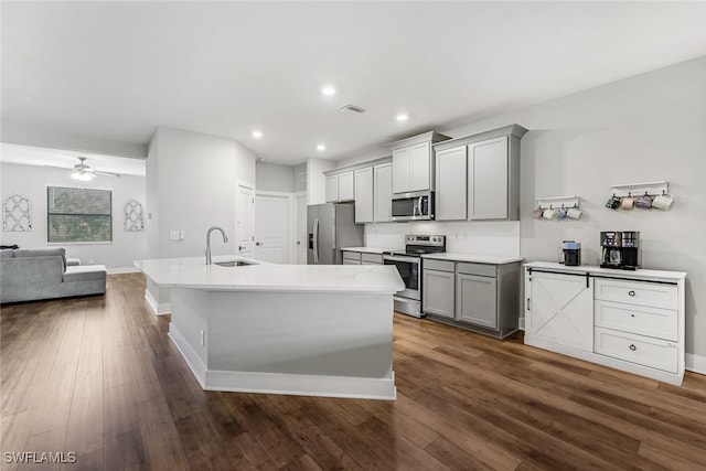 kitchen featuring gray cabinetry, appliances with stainless steel finishes, sink, dark hardwood / wood-style flooring, and ceiling fan