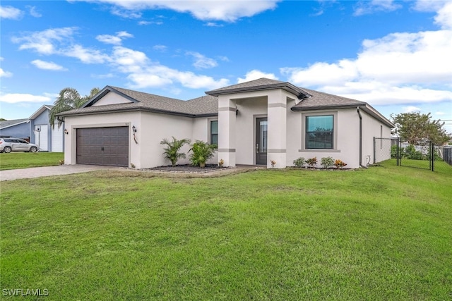 view of front of home featuring a front lawn and a garage