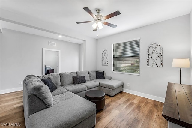 living room with ceiling fan and hardwood / wood-style flooring