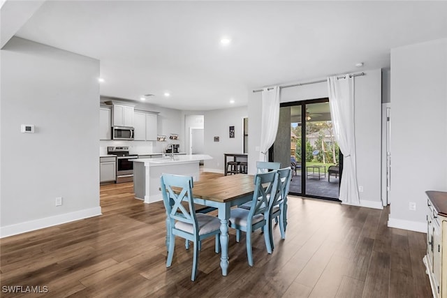 dining area with dark hardwood / wood-style flooring