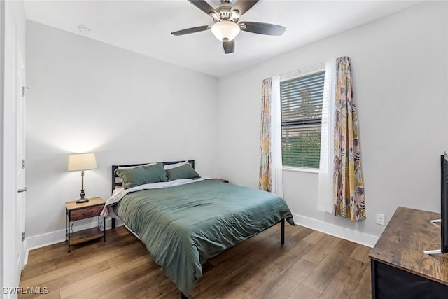 bedroom with ceiling fan and hardwood / wood-style floors