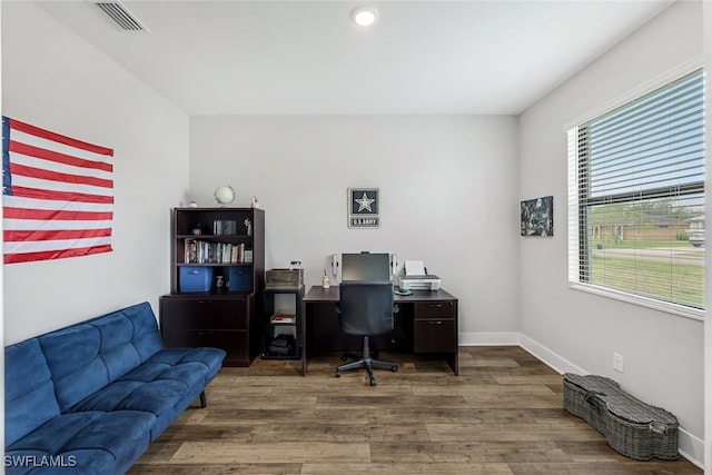 home office featuring a wealth of natural light and hardwood / wood-style flooring