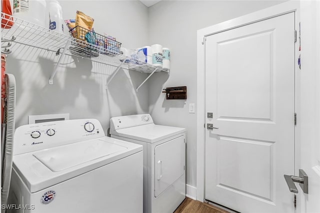 washroom with separate washer and dryer and dark hardwood / wood-style floors