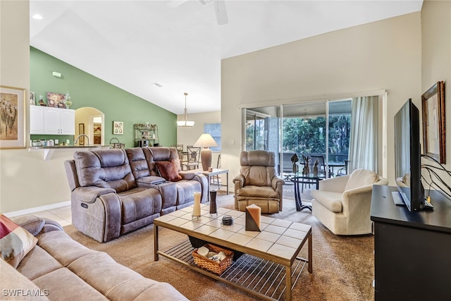 carpeted living room with high vaulted ceiling and ceiling fan