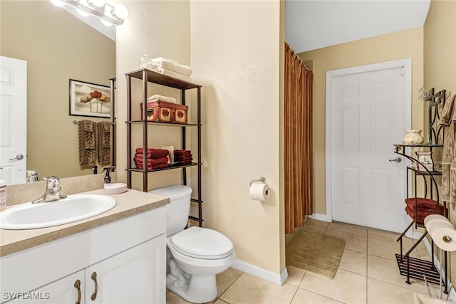 bathroom with vanity, toilet, and tile patterned floors