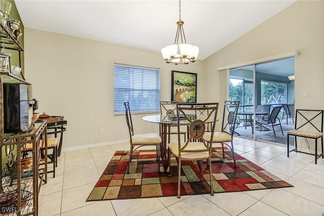 tiled dining room featuring a wealth of natural light, vaulted ceiling, and a notable chandelier