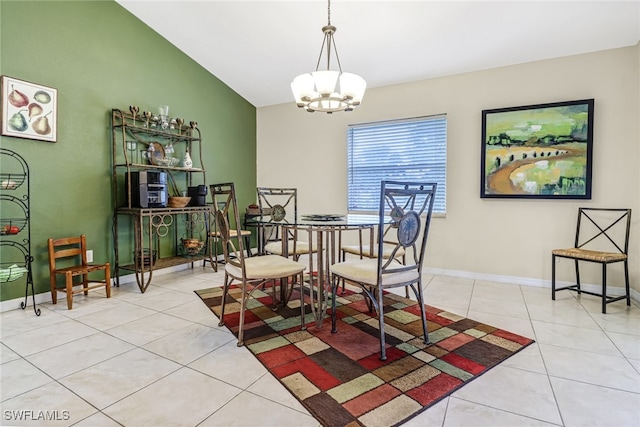 tiled dining space with a notable chandelier and lofted ceiling