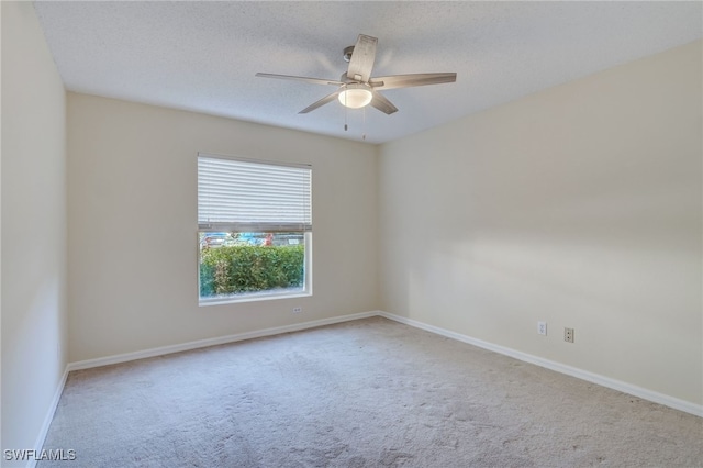 carpeted empty room with a textured ceiling and ceiling fan