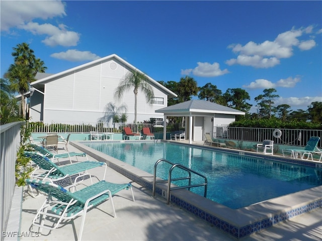 view of pool featuring an outdoor structure and a patio area