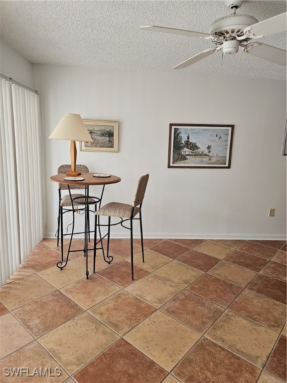 dining room with ceiling fan and a textured ceiling