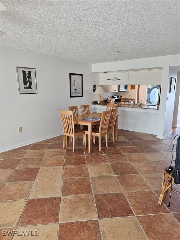 dining space featuring a textured ceiling