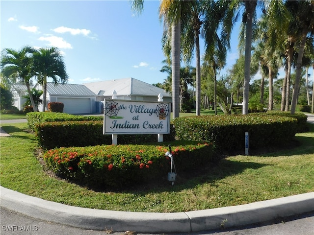 community sign featuring a lawn