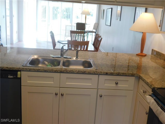 kitchen featuring sink, black appliances, white cabinetry, and light stone counters