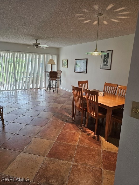 dining room featuring ceiling fan and a textured ceiling