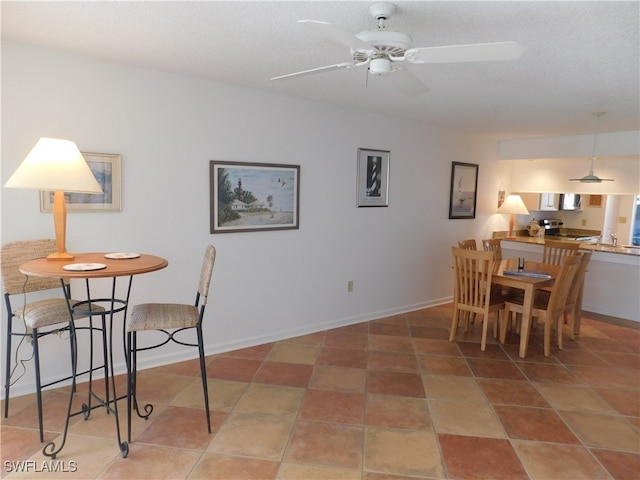 dining space with tile patterned floors, a textured ceiling, and ceiling fan