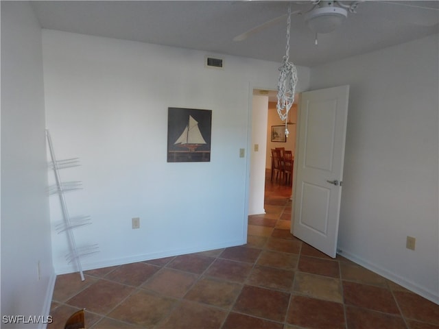 unfurnished room with dark tile patterned floors